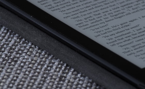 A sleek dark Kindle reader displaying the AI Author Accelerator ebook cover.