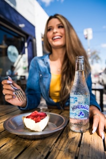 A smiling person enjoying a balanced meal outdoors on a sunny day.