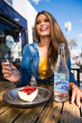 A happy person enjoying a gluten-free meal outdoors with natural sunlight.