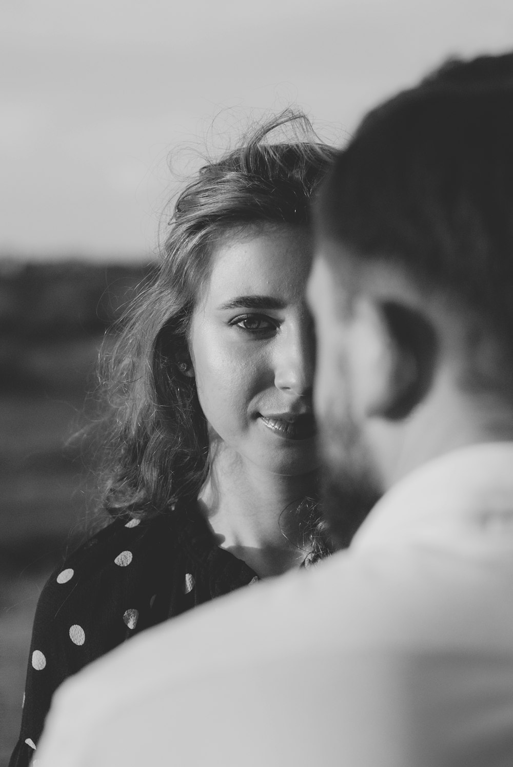 grayscale photo of woman smiling