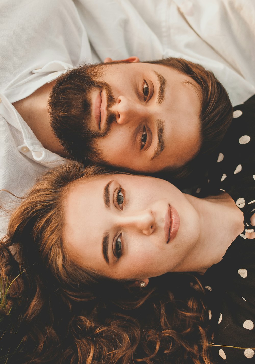 man and woman lying on bed