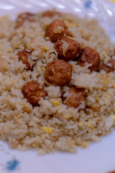 Close-up of teriyaki chicken rice balls garnished with sesame seeds.