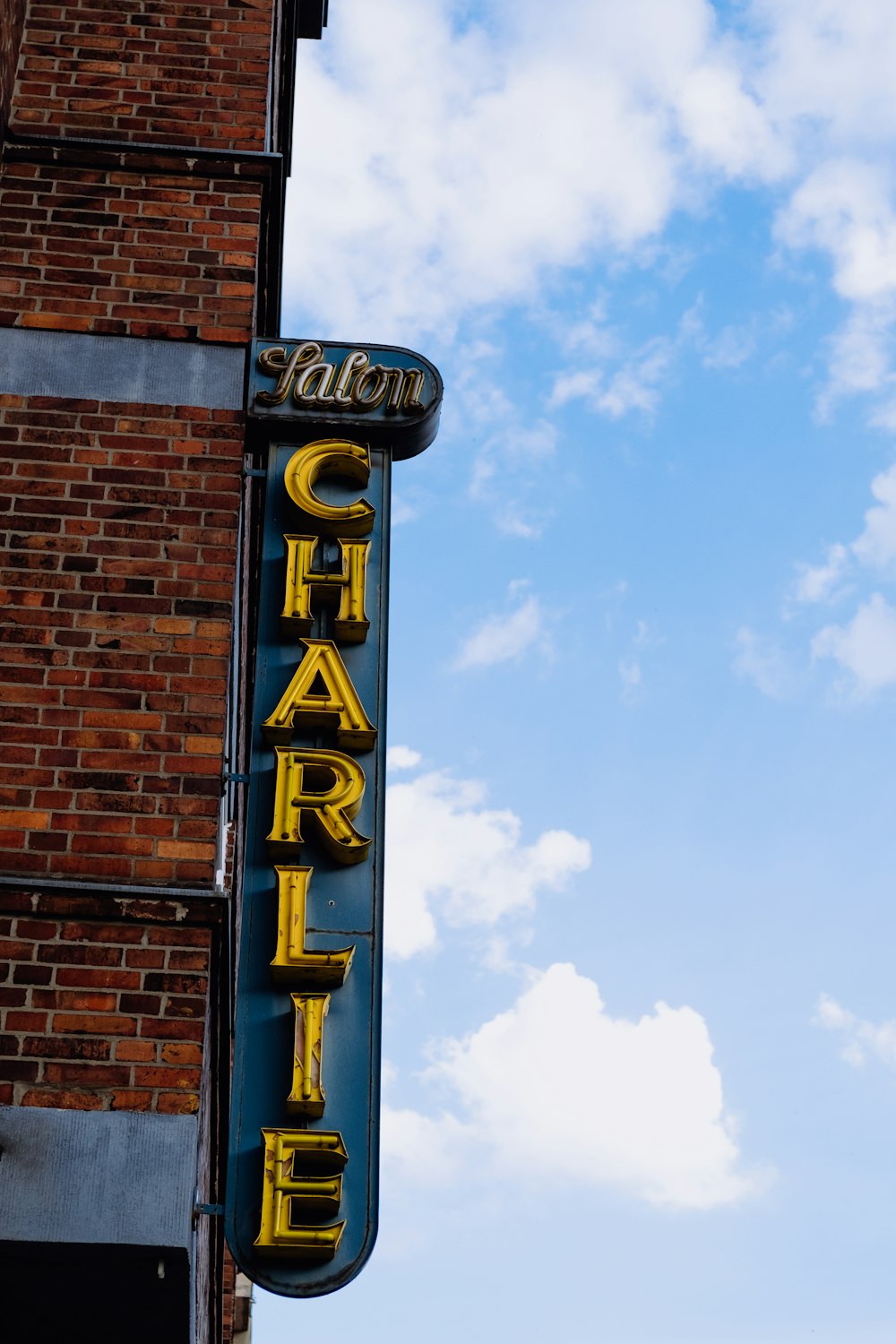 a close up of a street sign on a brick building