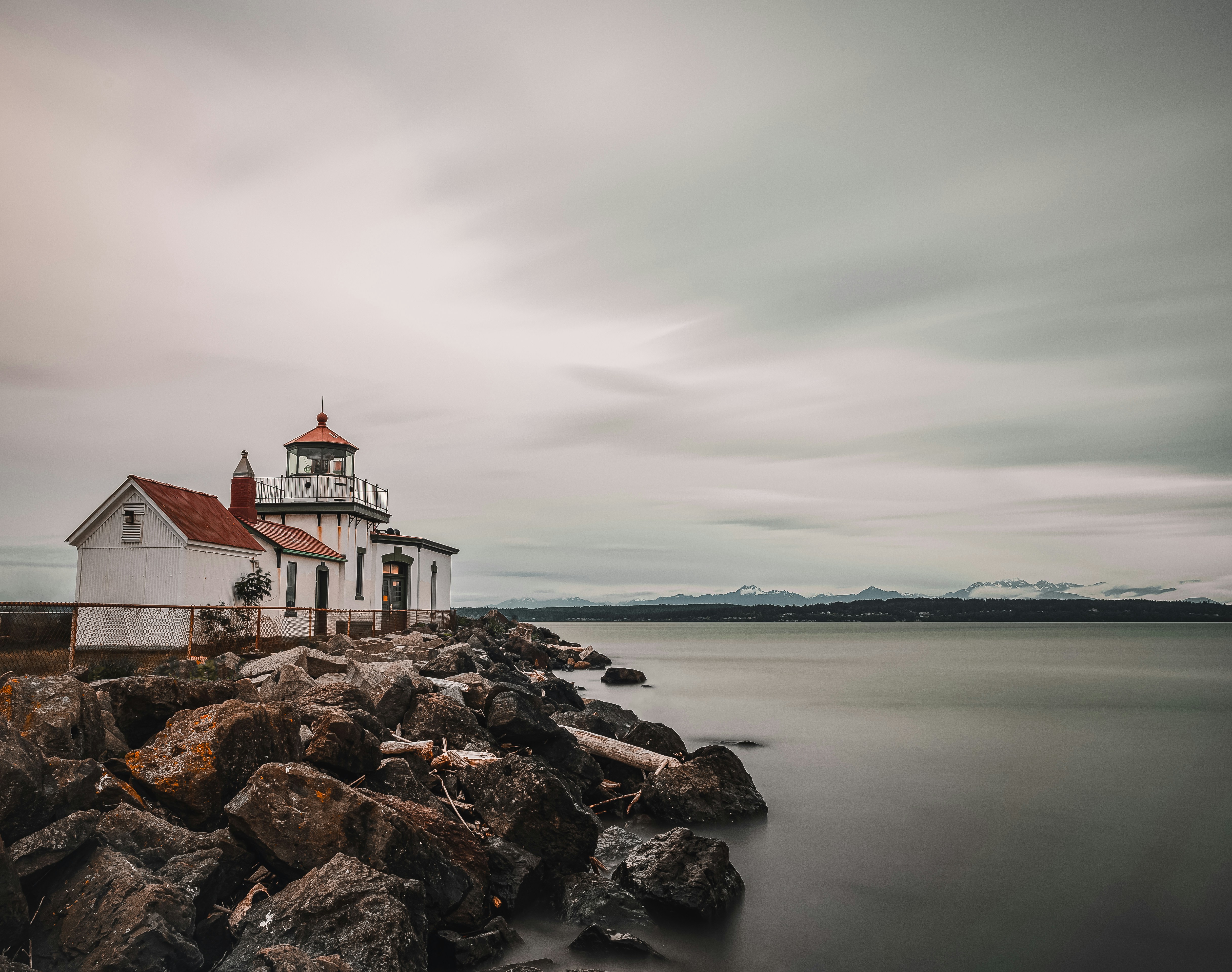 white and red concrete building near body of water during daytime