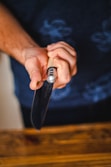 person holding black and silver tube type vape