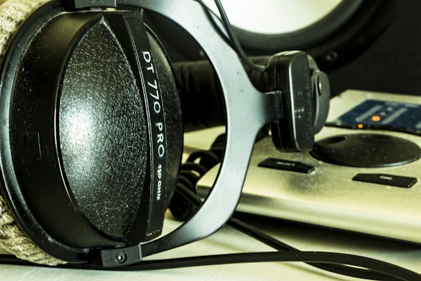 Close-up of headphones resting on a mixing desk in a creative studio