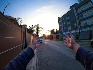 A warm handshake between two contractors on a building site at sunset.