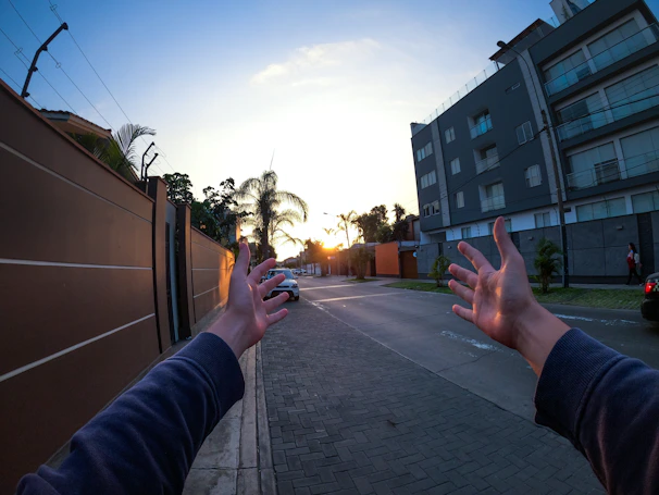 A warm handshake between two contractors on a building site at sunset.
