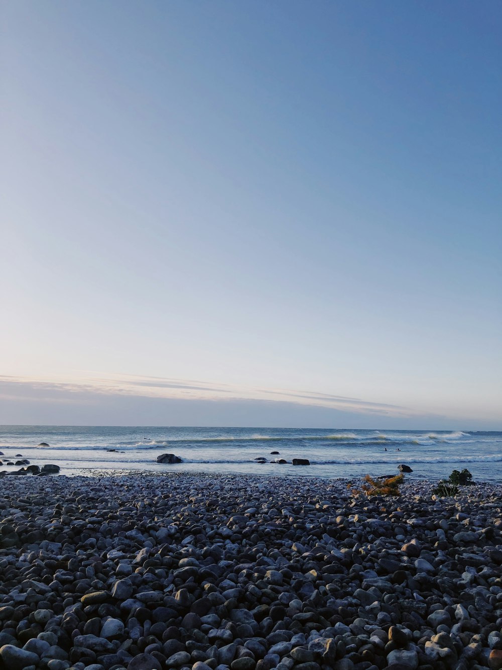 black and brown stones on seashore during daytime