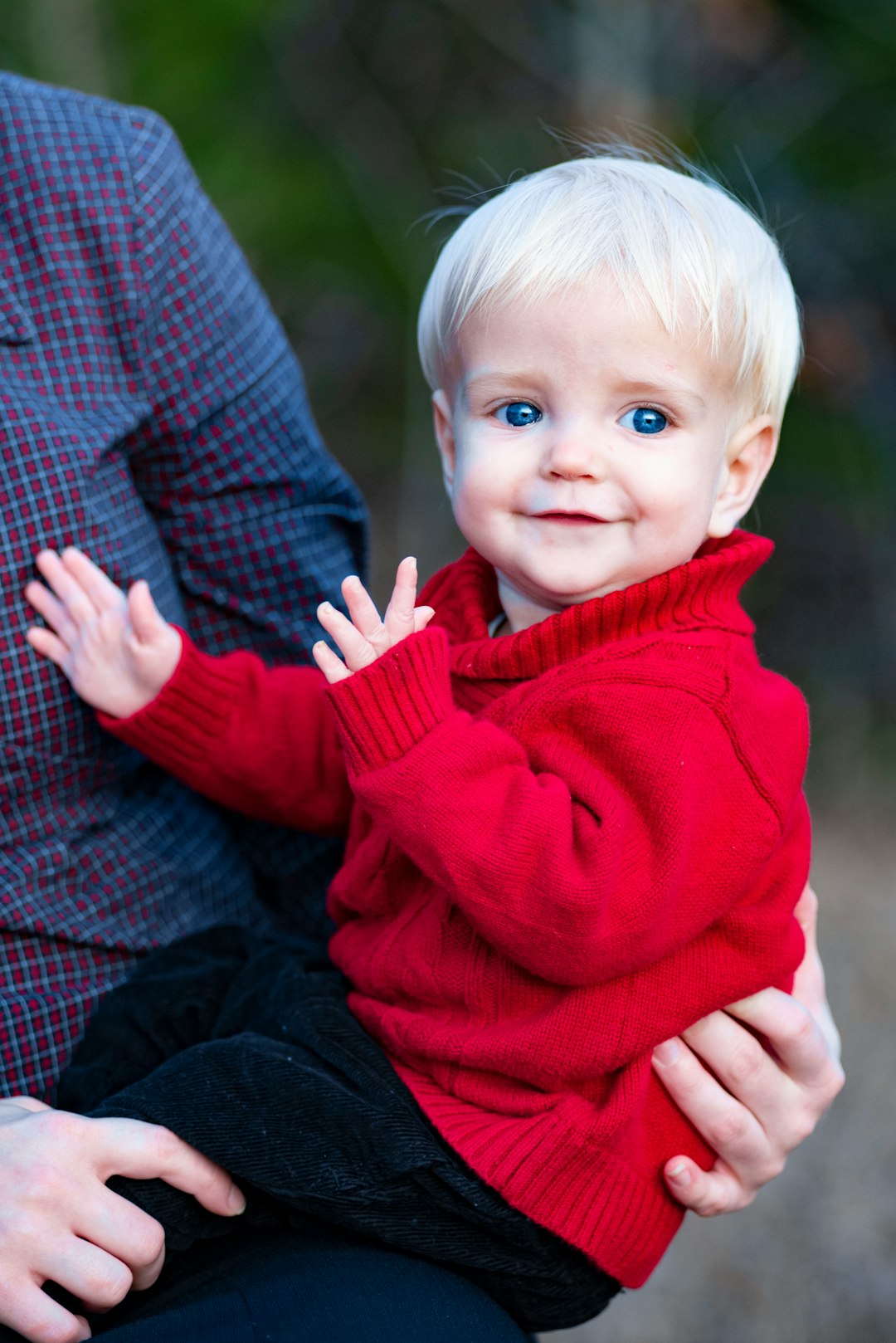 baby in red sweater and blue denim jeans