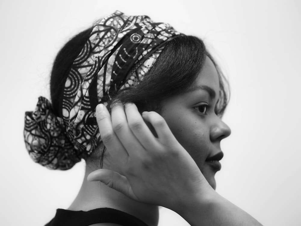 woman in black long sleeve shirt covering her face with her hair