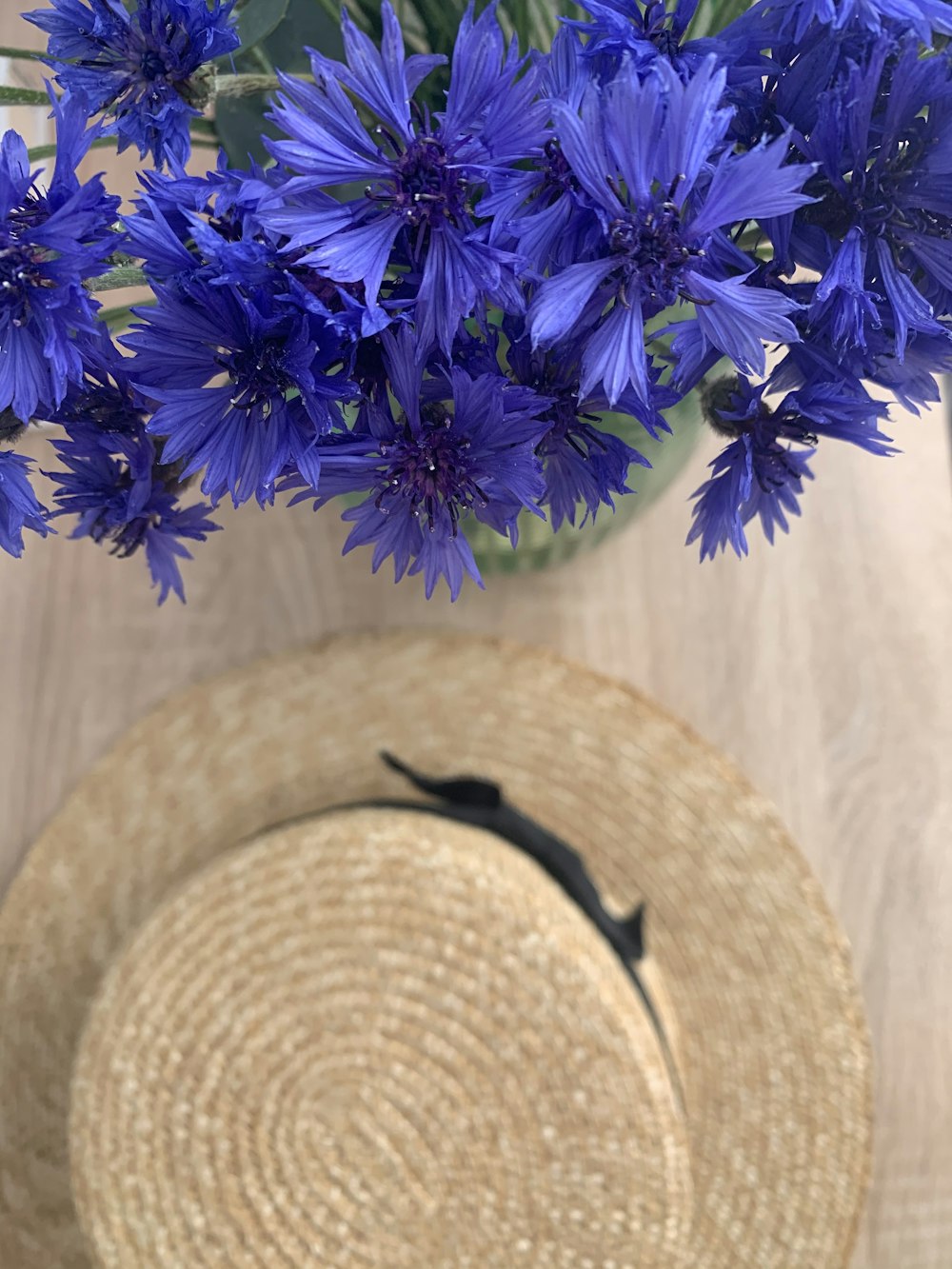 purple flowers on brown woven hat