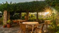 Beautiful garden terrace arranged for a cocktail reception on a sunny afternoon