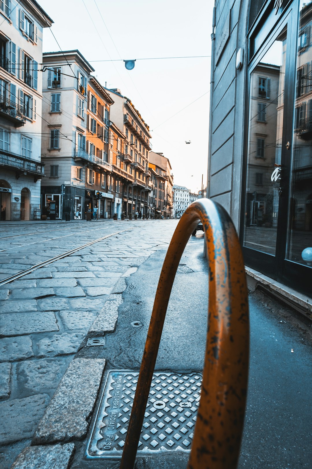 brown metal railings on sidewalk during daytime