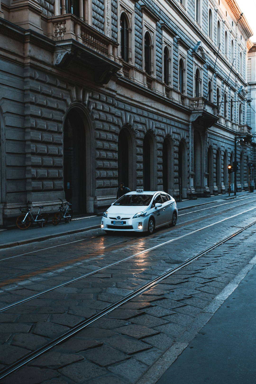 white car parked beside building