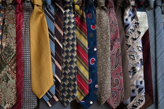 brown and white necktie on blue and white floral textile