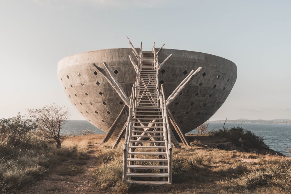 gray steel round structure on brown field during daytime