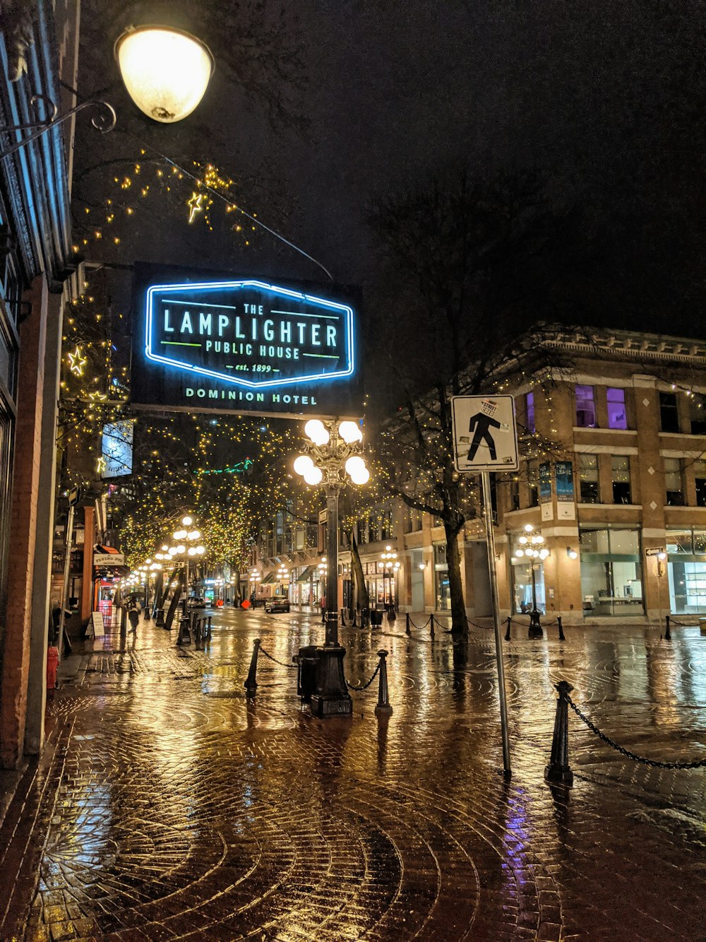 people walking on sidewalk during night time