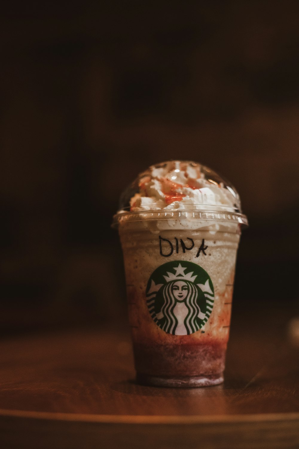 starbucks coffee cup on brown wooden table