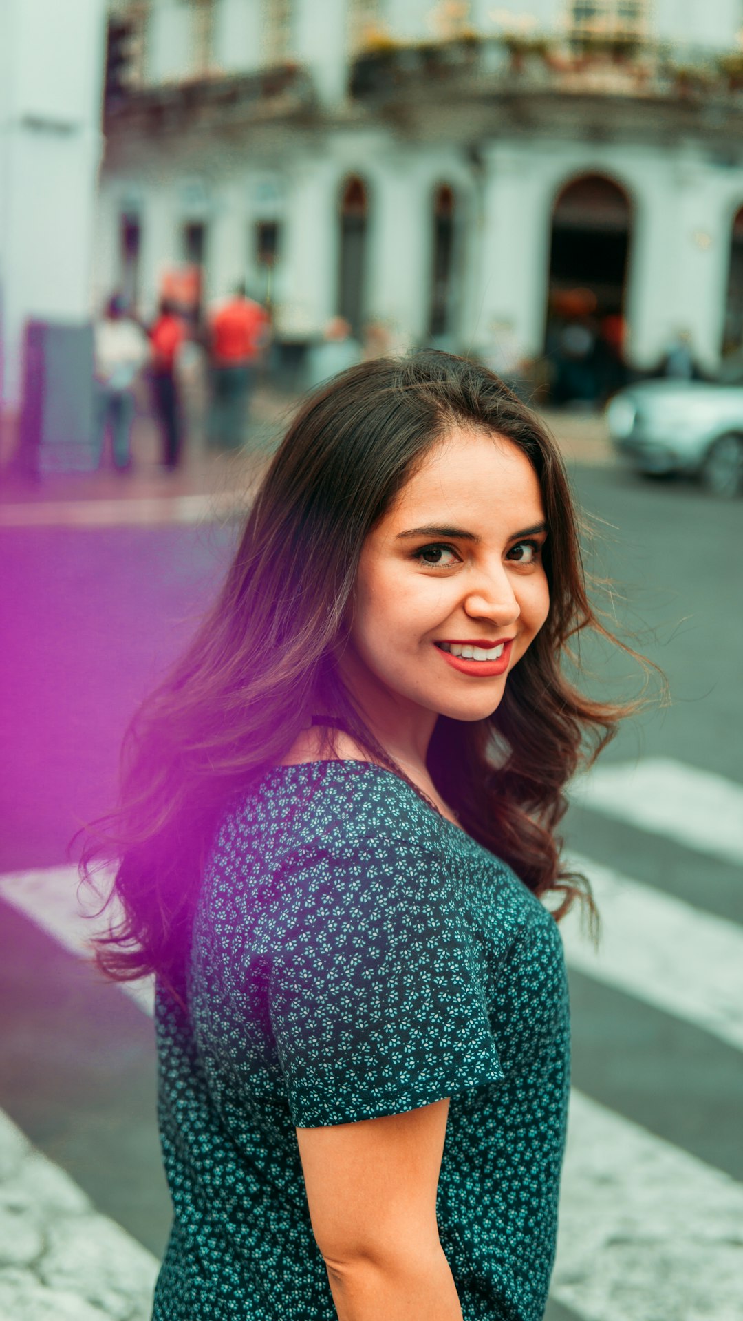 smiling woman in black and white shirt