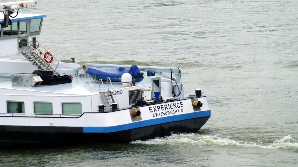 white and blue boat on sea during daytime