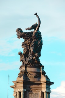 black statue of man with wings