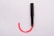 black and red tube on white surface