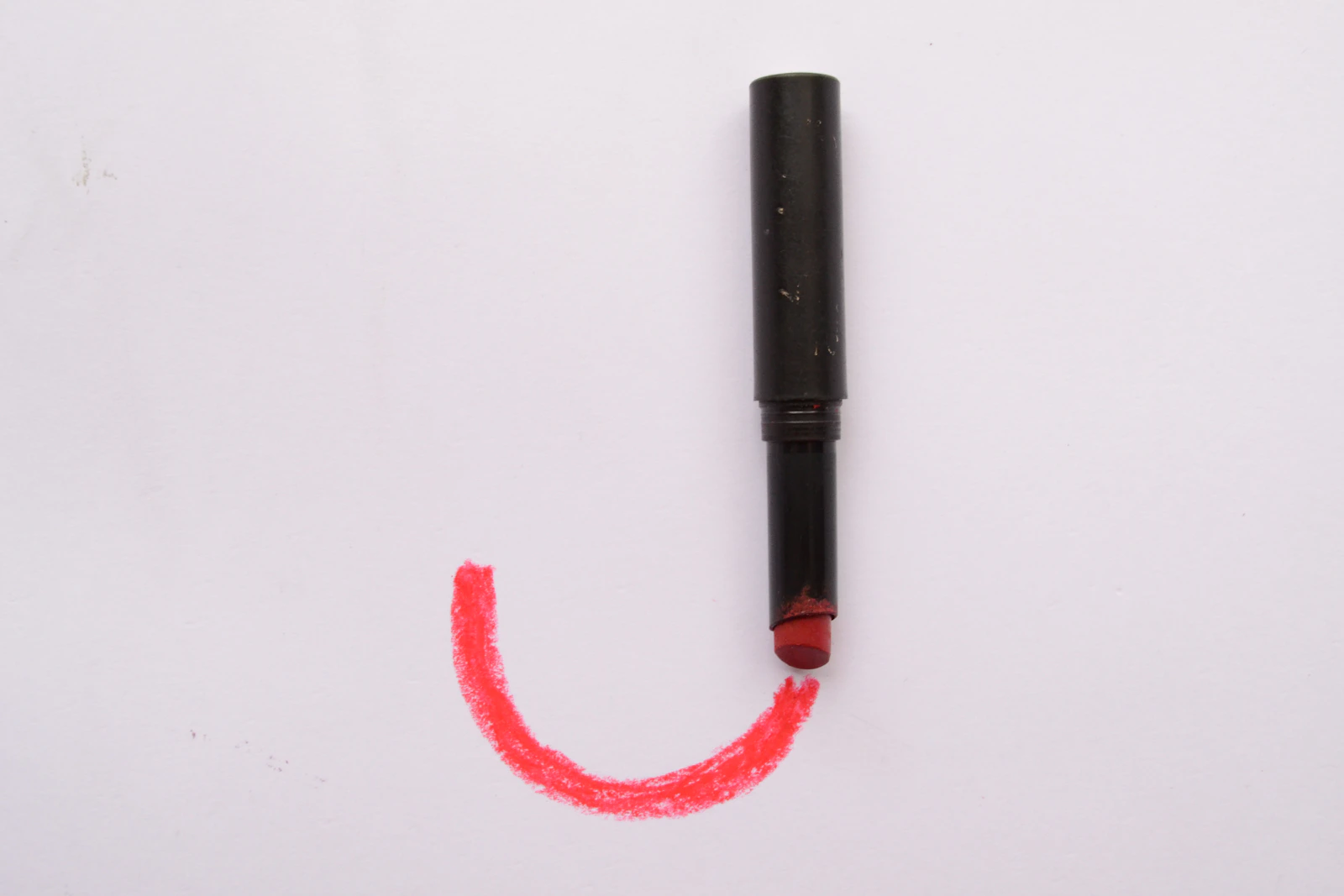 A rubber stamp mid-press onto a page, ink still wet