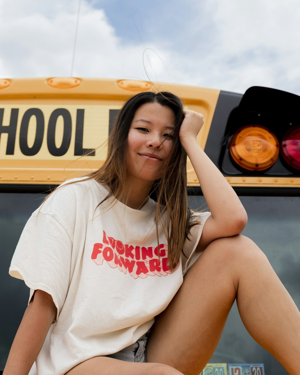 woman in white crew neck t-shirt sitting on yellow car