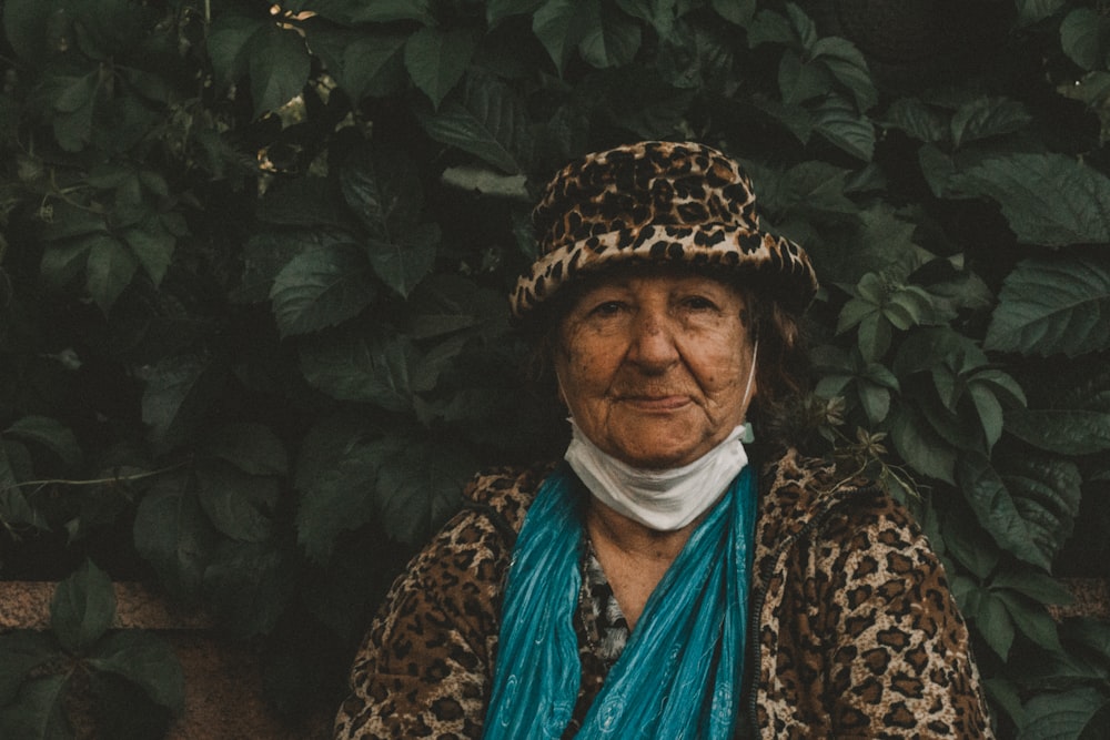 woman in black and brown leopard print coat wearing blue scarf