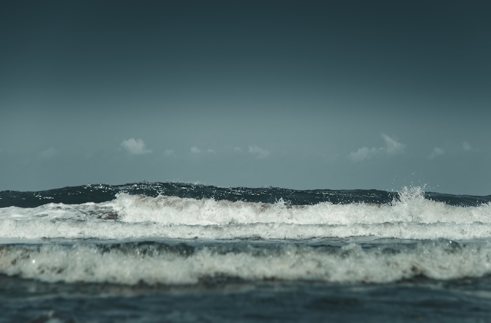 ocean waves under blue sky during daytime