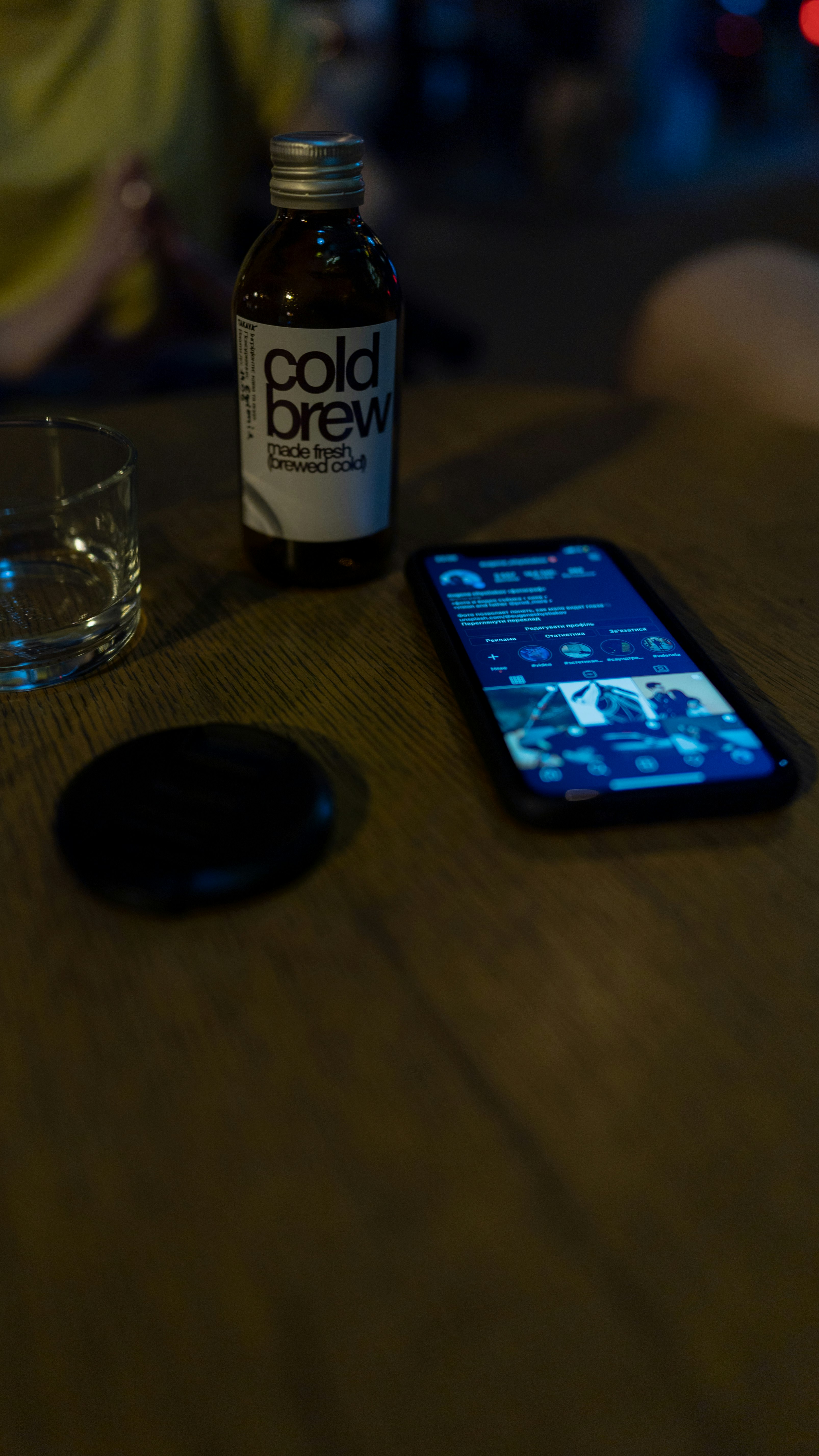 black iphone 5 beside clear drinking glass