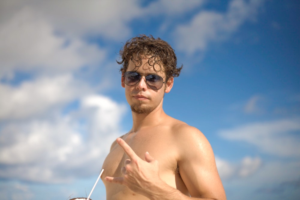 topless man wearing black sunglasses