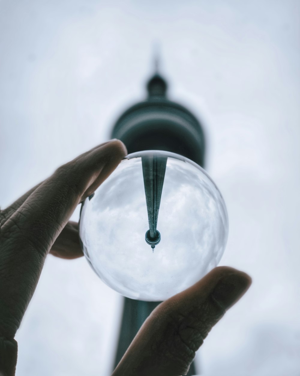 person holding clear glass ball