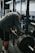 man in black t-shirt and black shorts carrying black barbell