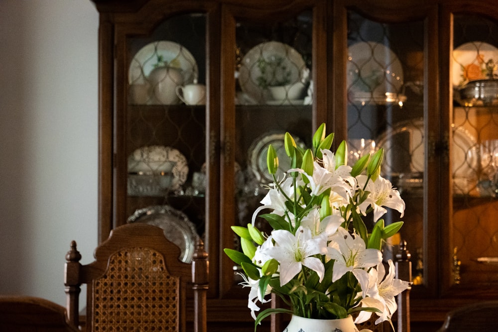 white and green flower in white ceramic vase