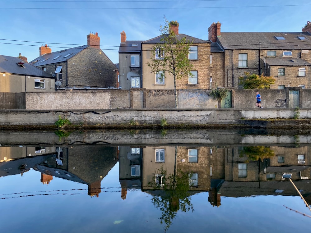 brown brick building beside river during daytime