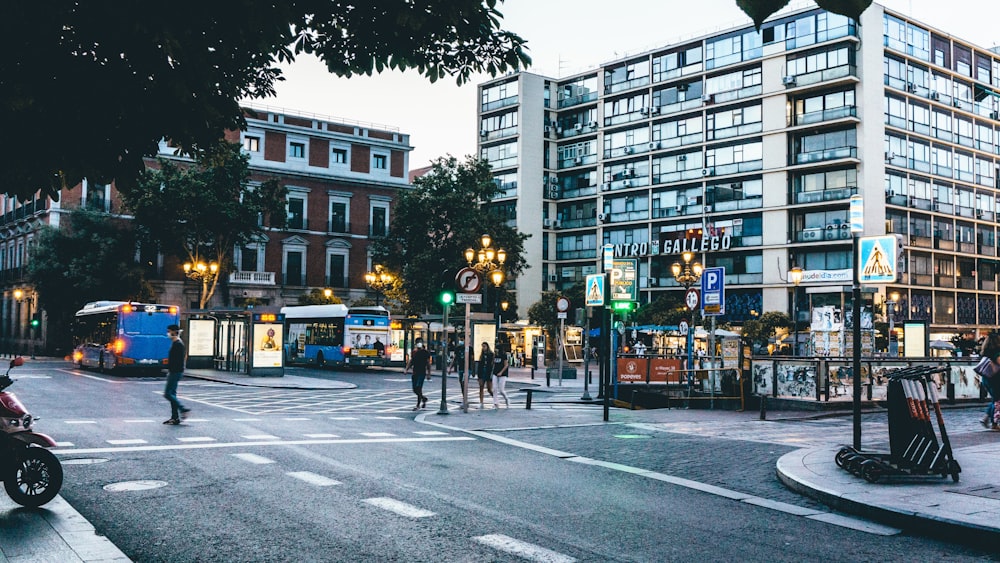 people walking on pedestrian lane near buildings during daytime