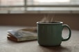 white ceramic mug on white table