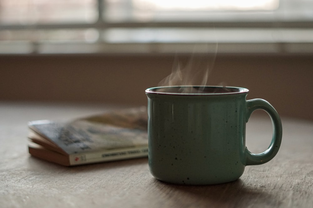 white ceramic mug on white table