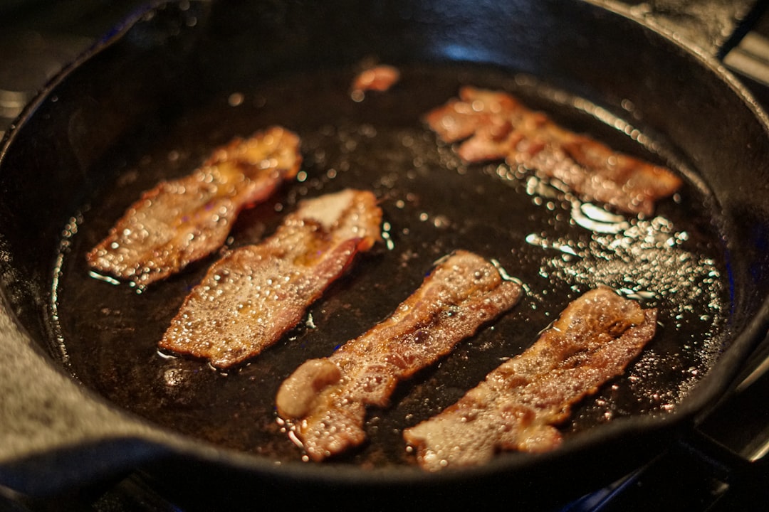 Bacon cooking in a cast iron skillet
