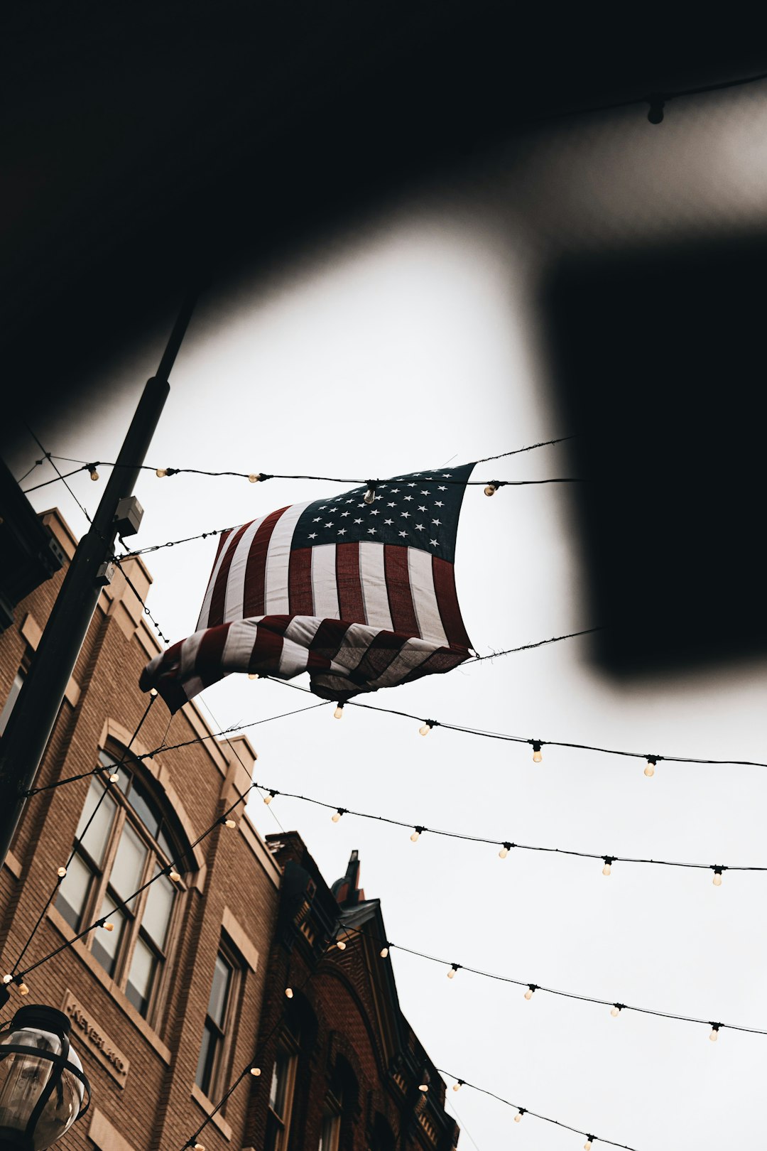 black and white star flag on brown concrete building during daytime