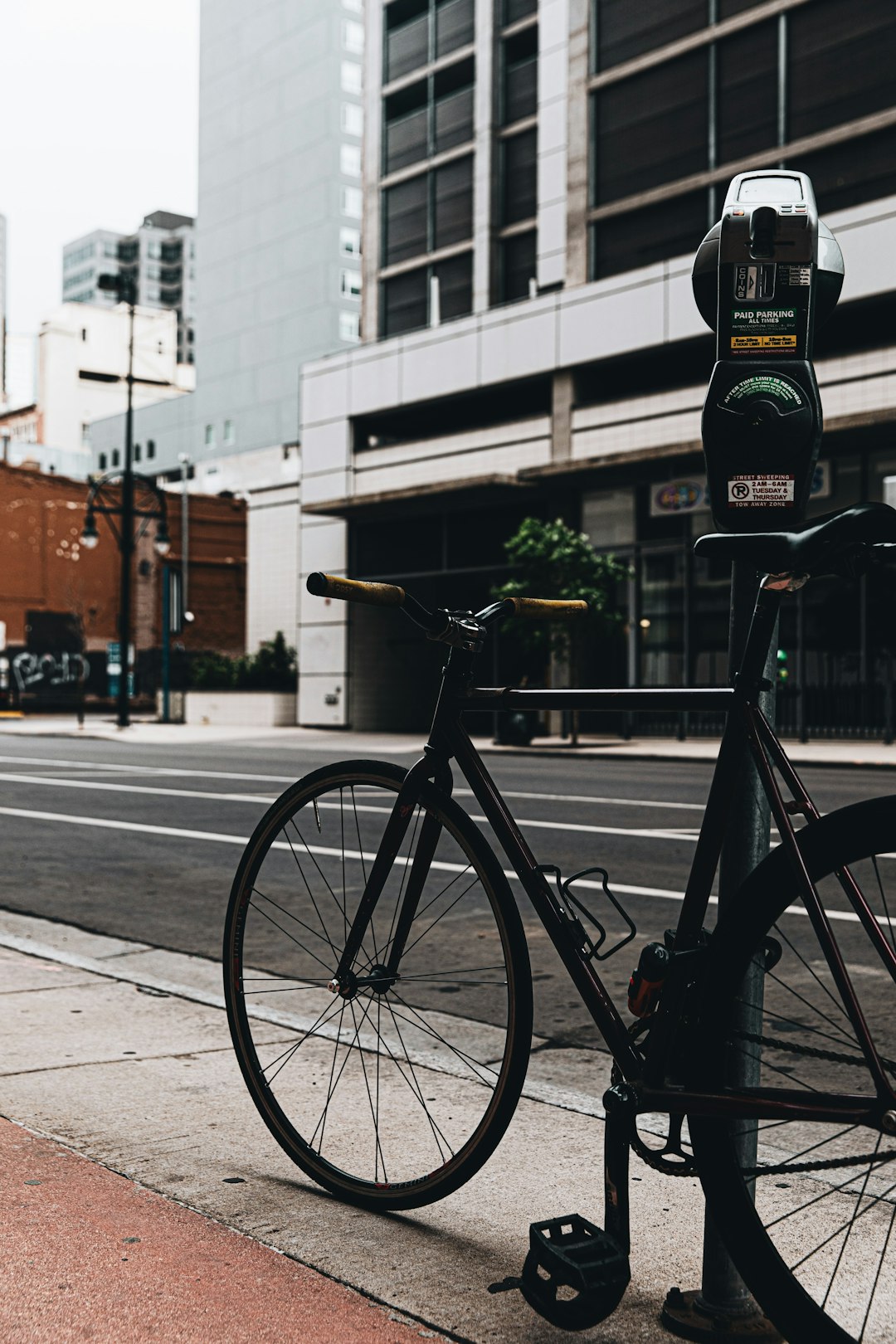 black bicycle parked on sidewalk during daytime