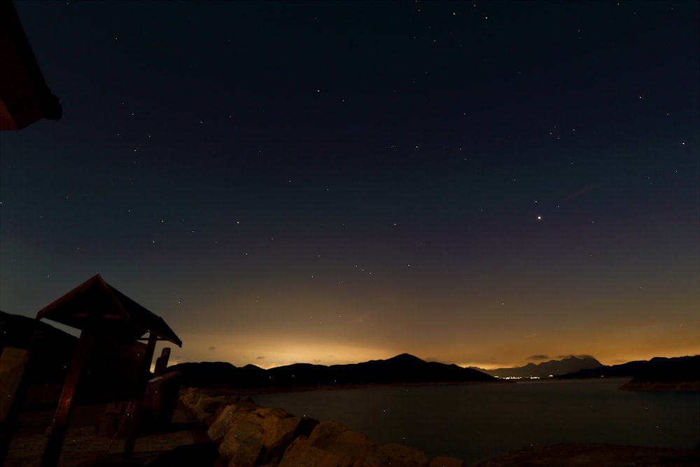 silhouette of house on hill during night time