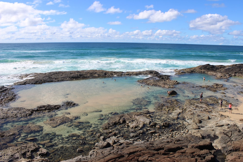 sea waves crashing on shore during daytime