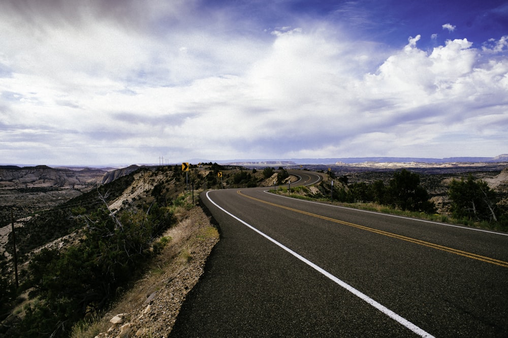 gray asphalt road under blue sky during daytime