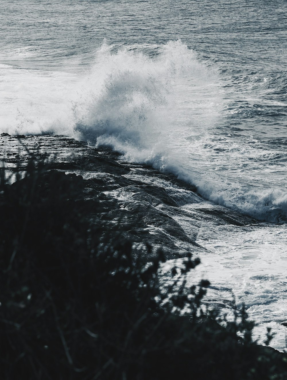 ocean waves crashing on rocky shore during daytime