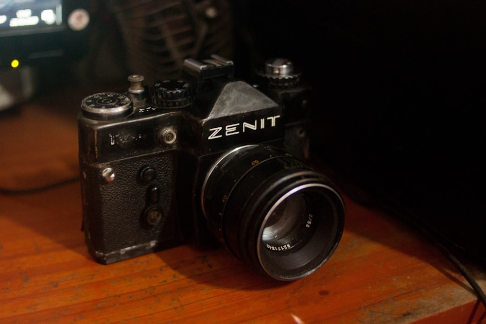 black nikon dslr camera on brown wooden table