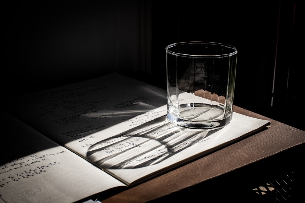 clear drinking glass on white printer paper