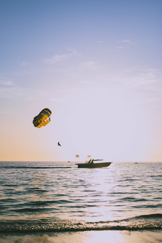 person in yellow and blue parachute over the sea during daytime in Langkawi Malaysia